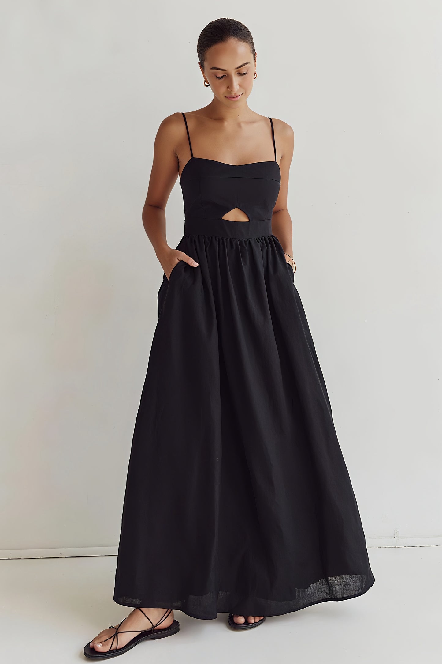 Kaia Dress in black cotton – standing front view with hands on waist